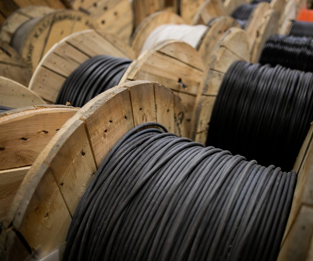 Wooden Coils Of Electric Cable Outdoor. High and low voltage cables in the storage Wooden Coils Of Electric Cable Outdoor. High and low voltage cables in the storage